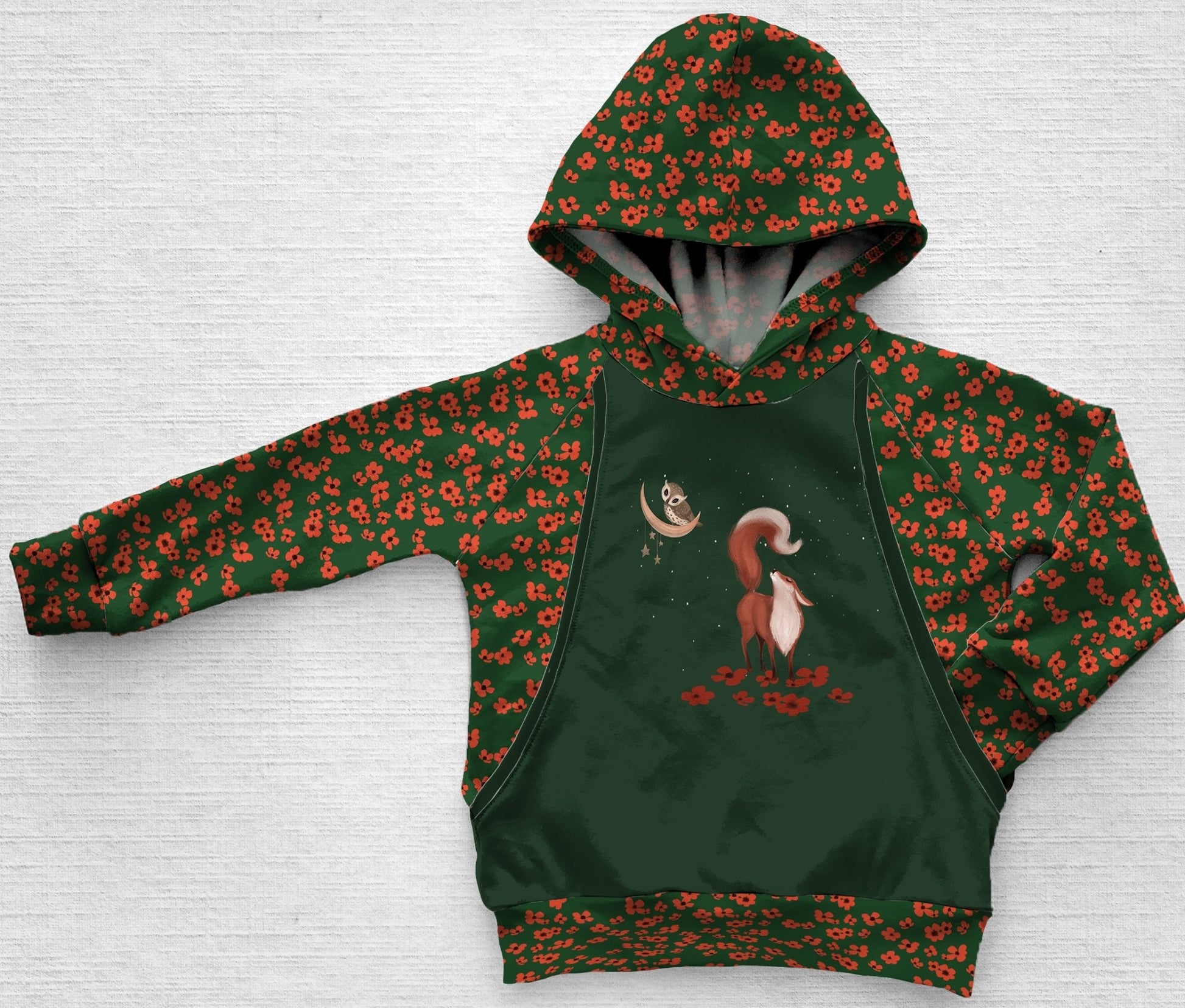 A dark green panel hoodie of a fox with an orange poppy floral print