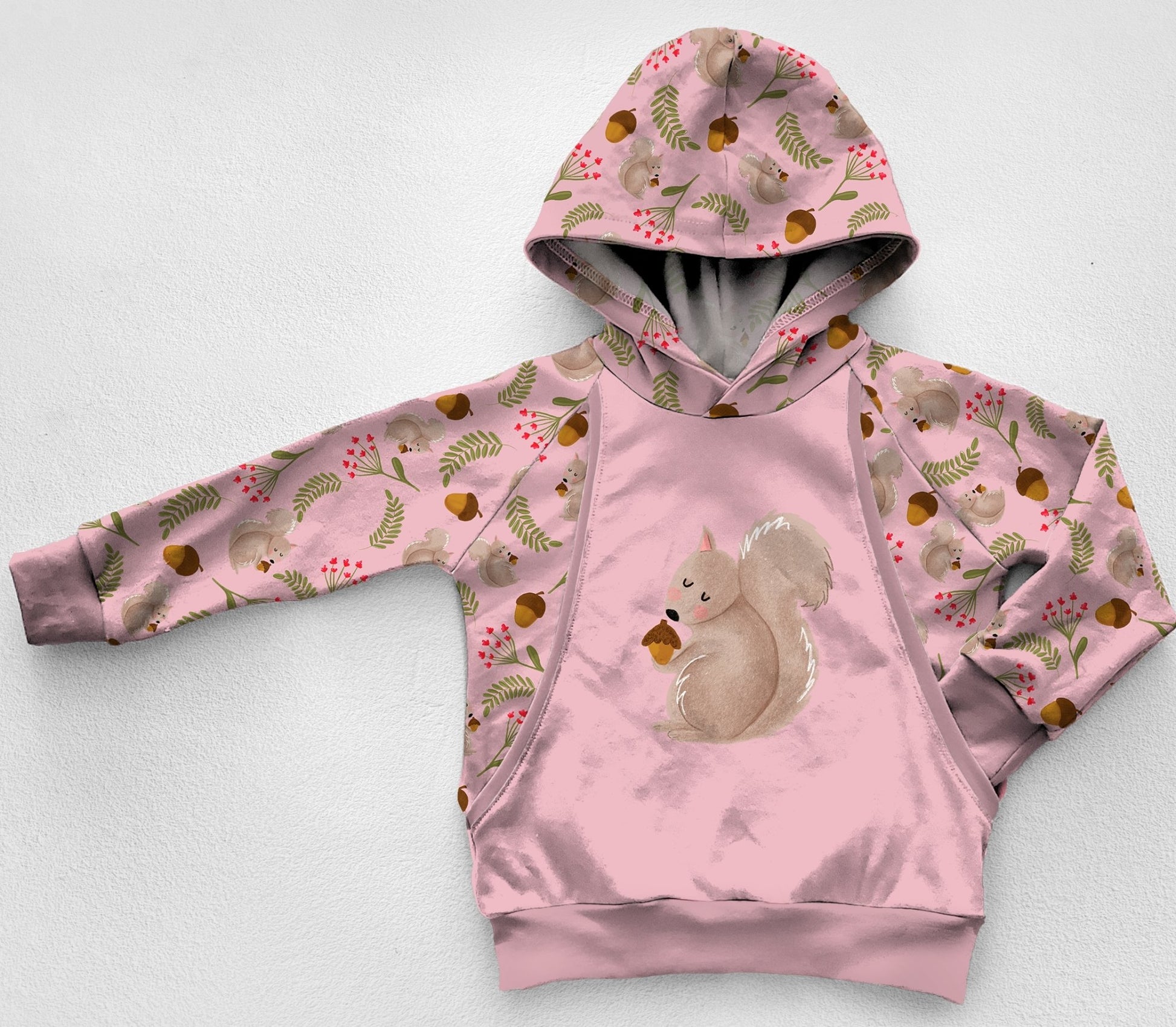 Pink panel hoodie with squirrels and acorns