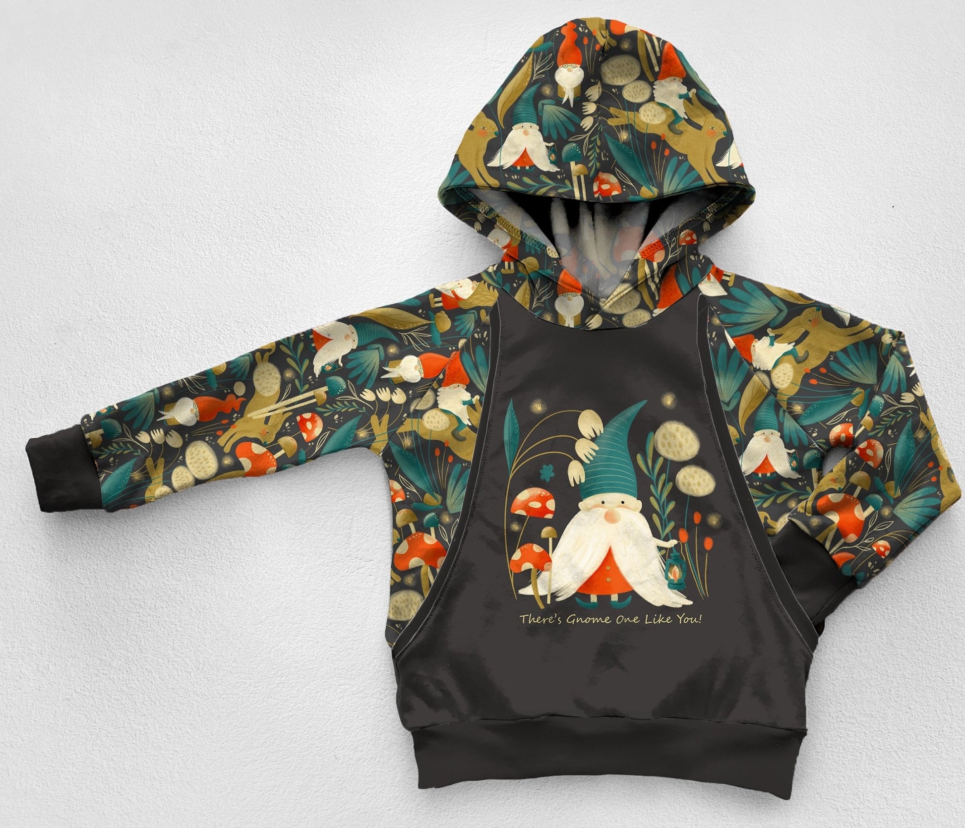 A dark grey panel hoodie with a gnome standing in a meadow at night with the words "There's Gnome One Like You"