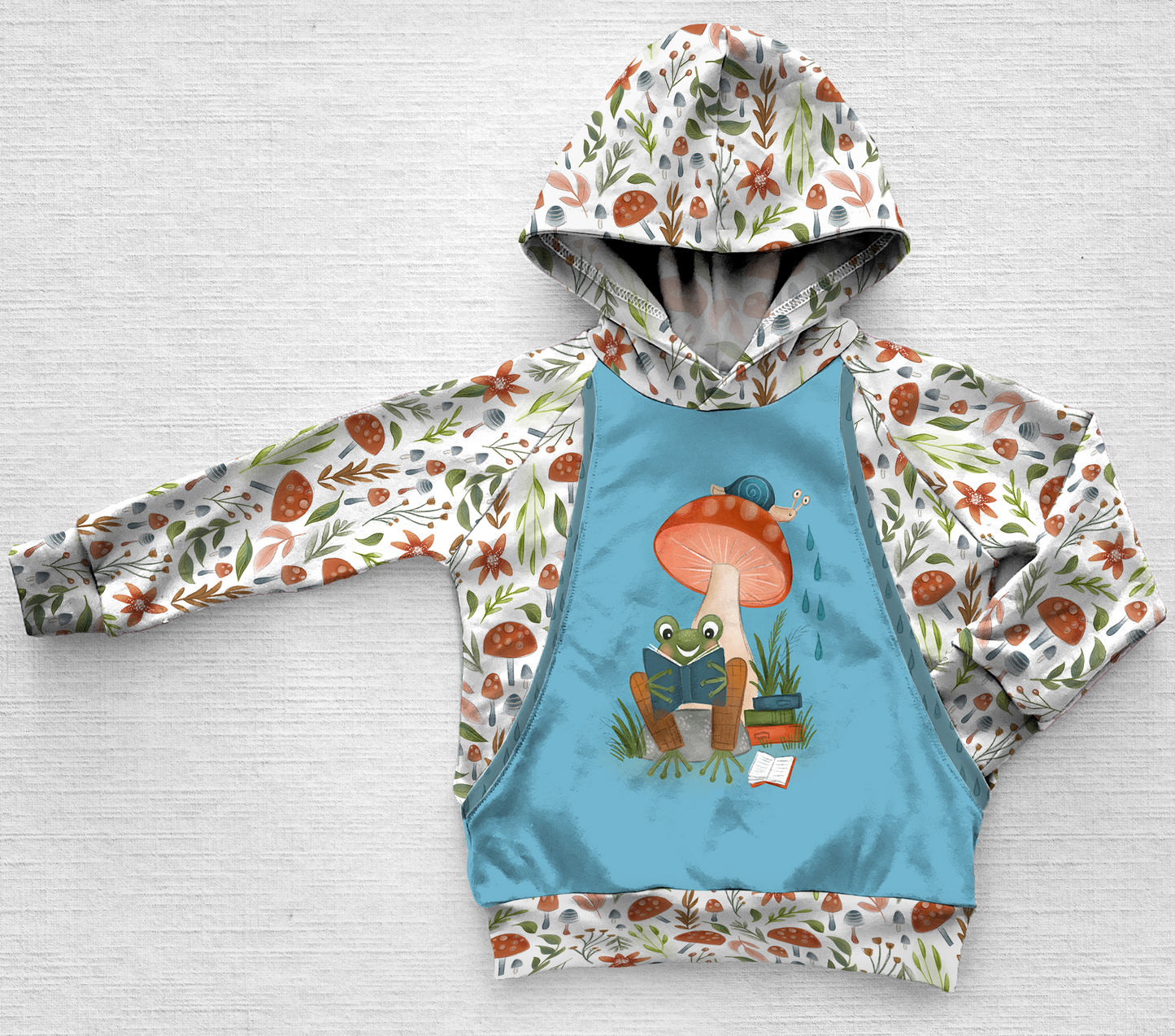 A panel hoodie with a frog, snail and mushrooms
