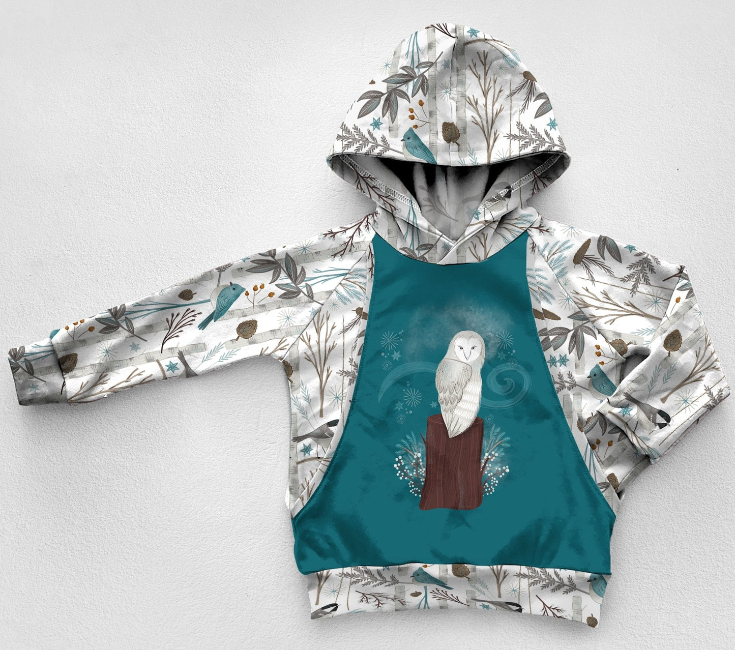 A blue and white woodland forest print panel hoodie with a snow owl 