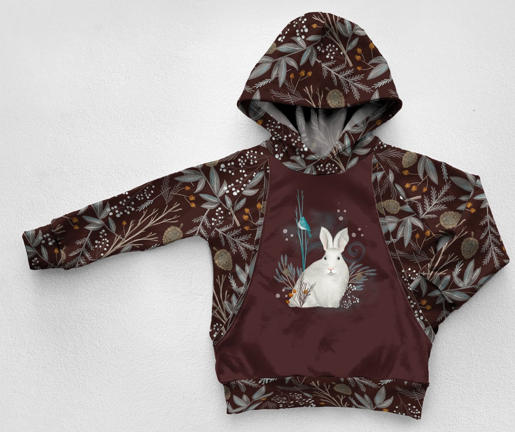 A snow hare panel hoodie with a dark brown fabric with woodland greens fabric 