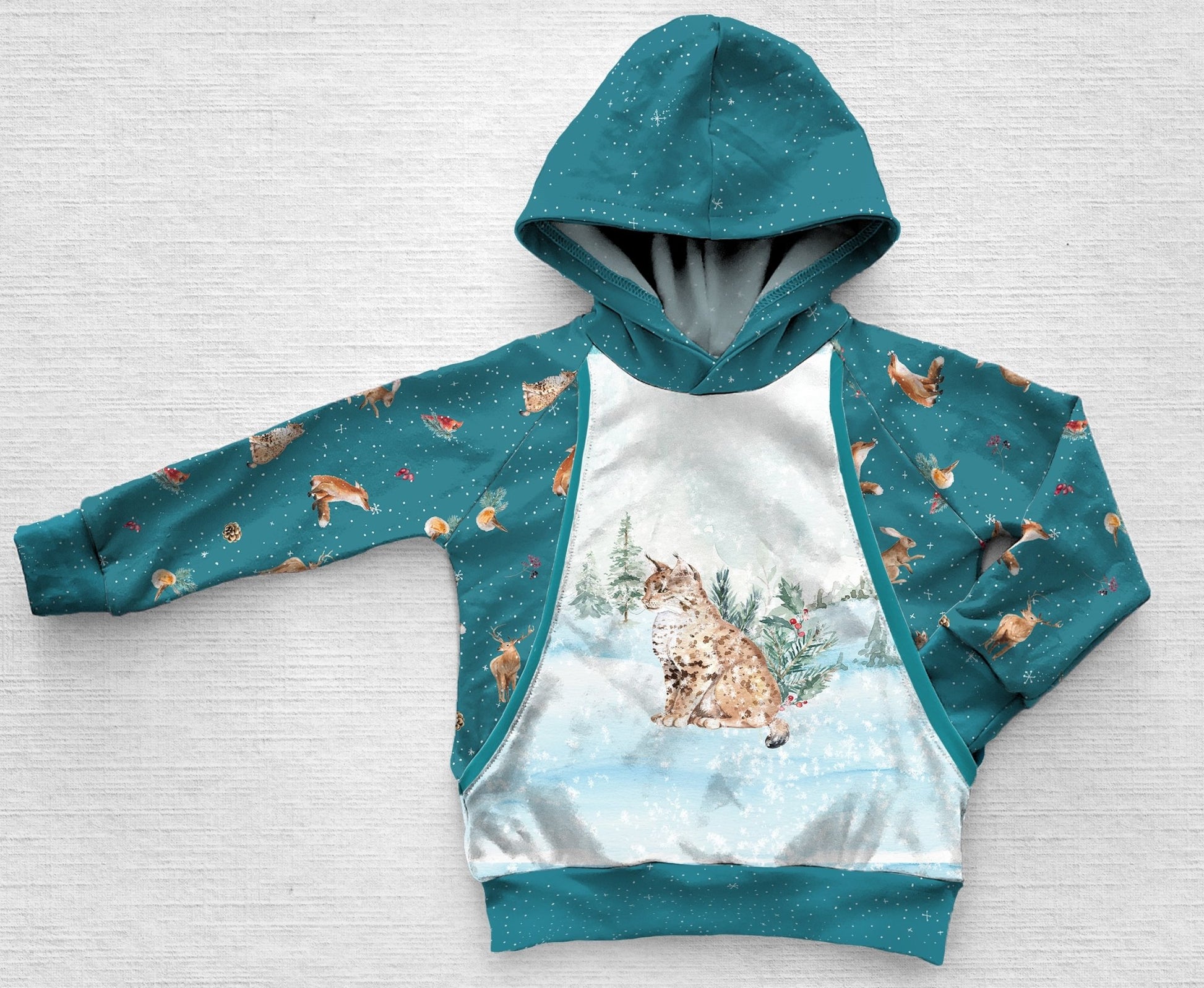 A  blue panel hoodie with a bobcat in the snow 