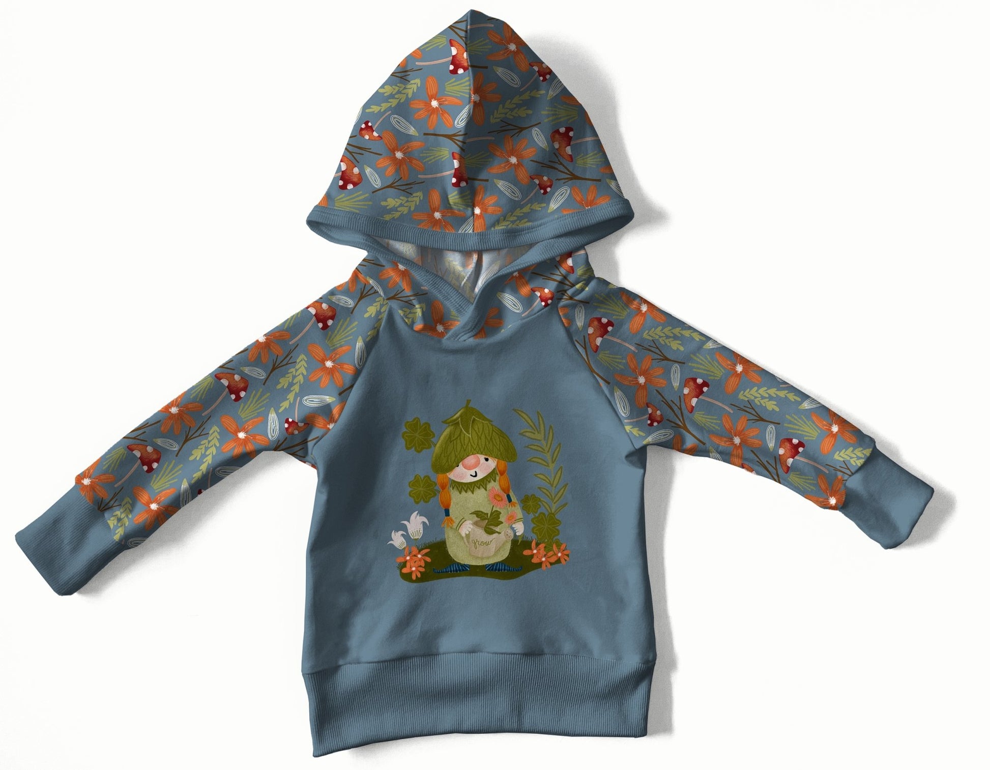 Blue hoodie with a floral and mushroom print. A girl gnome is on the front.  
